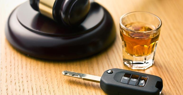Car key, alcohol and gavel